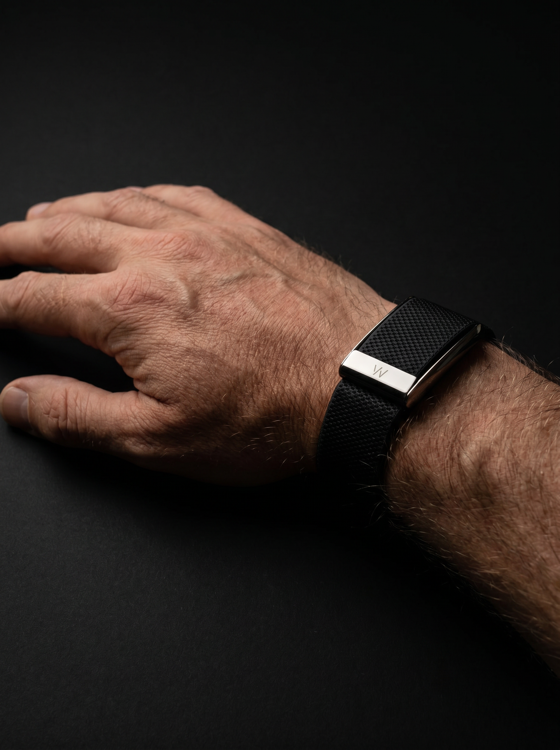 WHOOP band on the right wrist, editorial lighting. Continuous strain, recovery, and sleep.